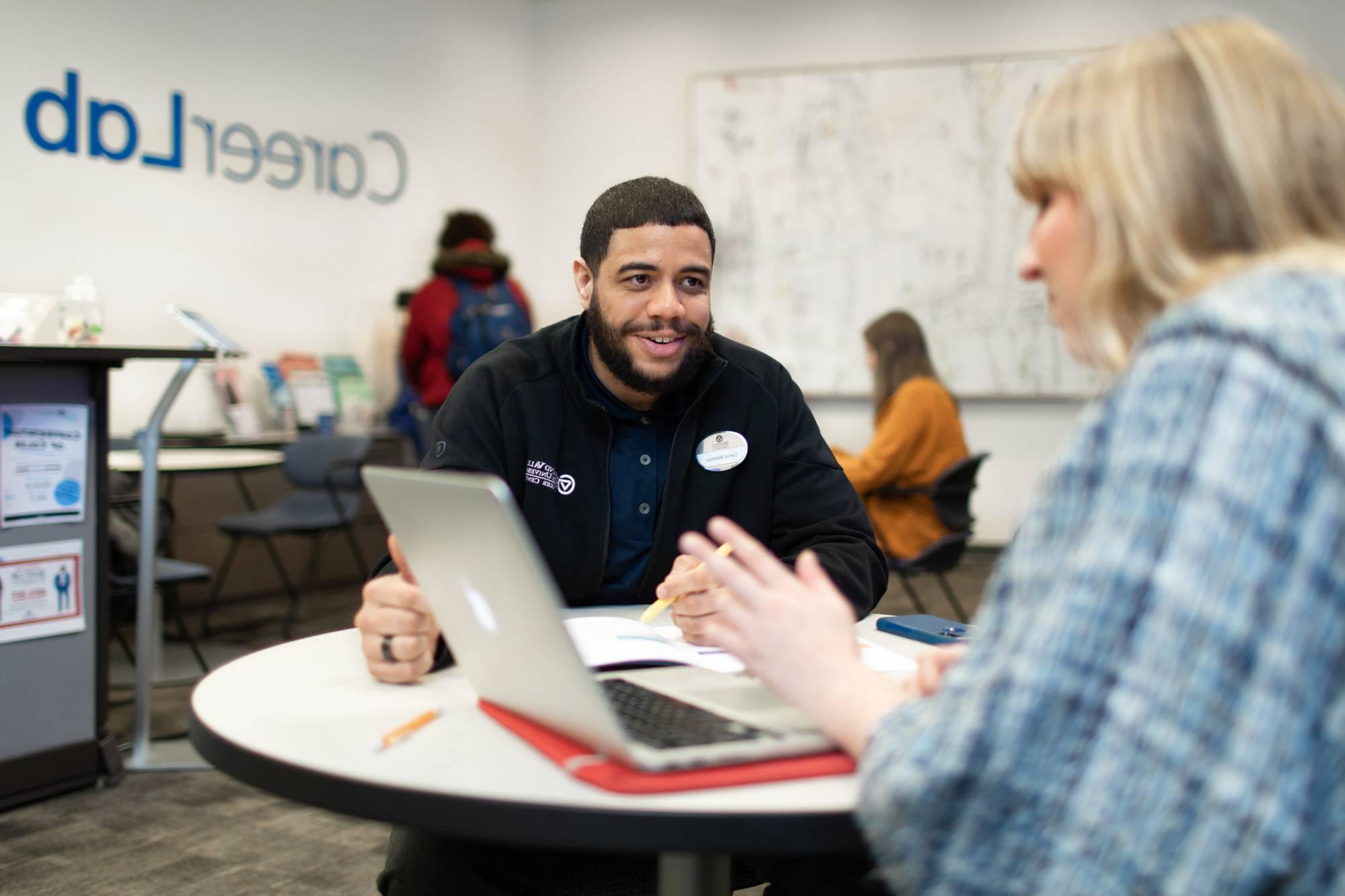 An alum networks at a career fair